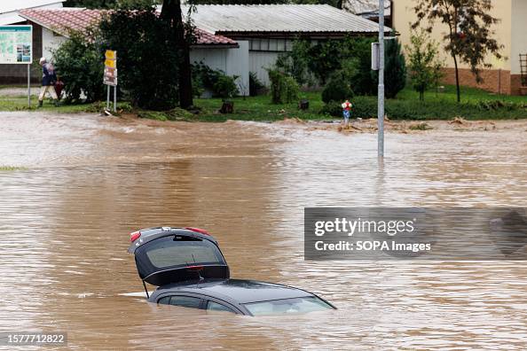 A car is trapped in floodwater as river Sora floods during A car is trapped in floodwater as river Sora floods during