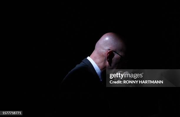 Delegate sits in a sunbeam during the European Election Assembly of German far-right party Alternative for Germany at the fair grounds in Magdeburg,...