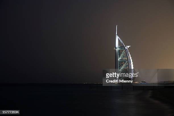 burj al arab hotel at night dubai united arabian emirates - burj al arab night stock pictures, royalty-free photos & images