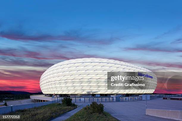 dawn over illuminated soccer stadium allianz arena in munich - allianz arena münchen stock pictures, royalty-free photos & images