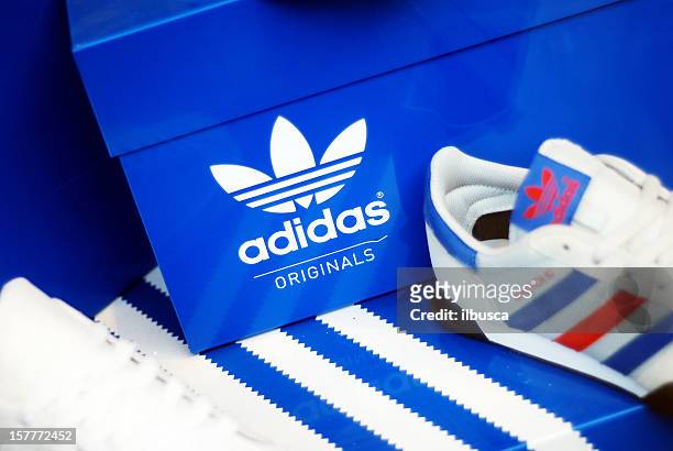 adidas shoes in store window - adidas shoes stock pictures, royalty-free photos & images