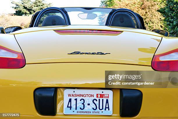 yellow porsche boxster sports car - license plate stockfoto's en -beelden