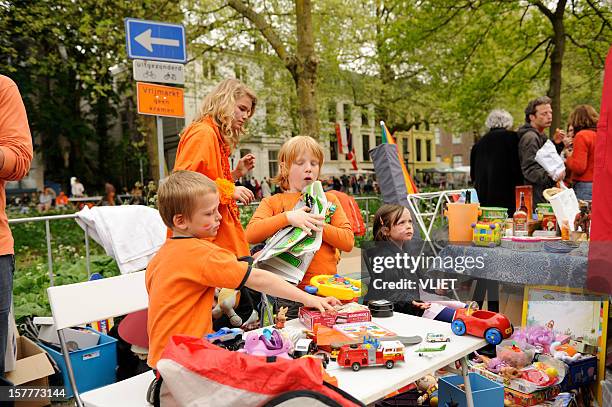 children selling toys on queen's day in utrecht - koninginnedag stock pictures, royalty-free photos & images