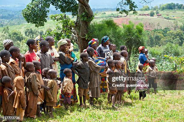 african children and women in a field, burundi - gitega stock pictures, royalty-free photos & images