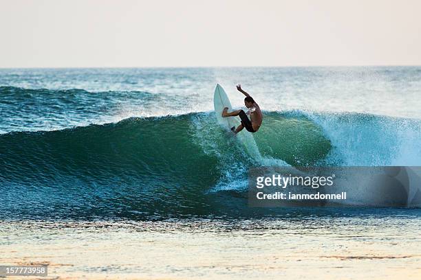 surfer riding a wave off the top - costa rica stock pictures, royalty-free photos & images