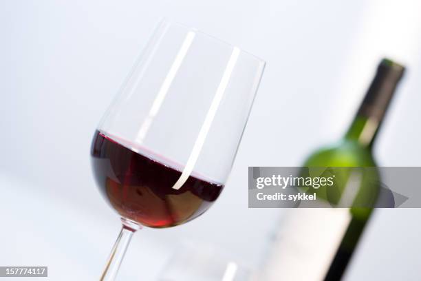 red wine in glass - merlot stock pictures, royalty-free photos & images