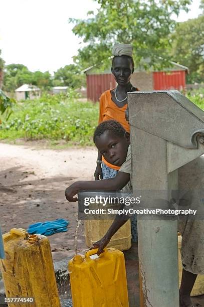 pumping water in south sudan, africa. - south sudan stock pictures, royalty-free photos & images