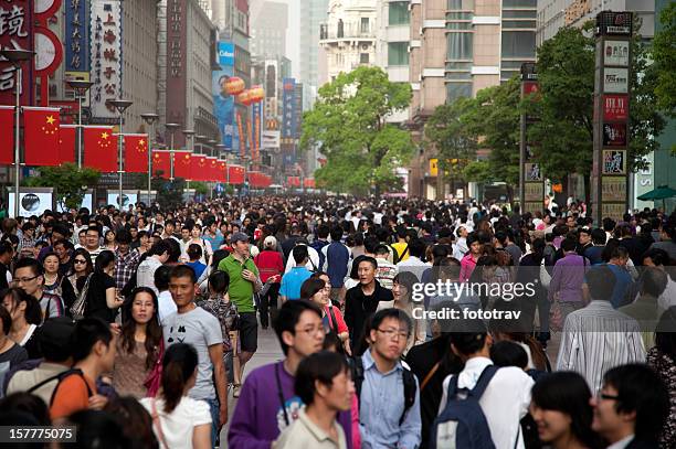 foreign tourist lost in middle of chinese crowd, shanghai, china - middle class stock pictures, royalty-free photos & images