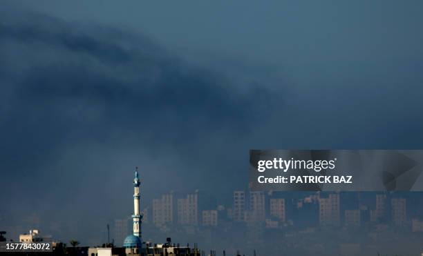 Smoke from Israeli artillery shelling covers Gaza City as a mosque in the town of Beit Hanun appears in the foreground on January 9, 2008 as seen...