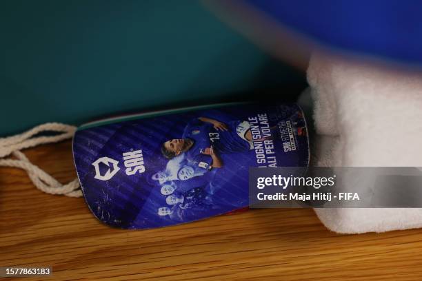 The shin guards of Elisa Bartoli are displayed inside the Italy dressing room prior to the FIFA Women's World Cup Australia & New Zealand 2023 Group...