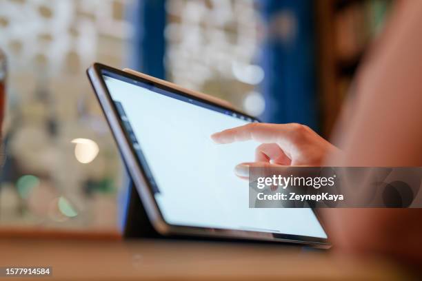 close-up to human hand on digital tablet screen - masters series stockfoto's en -beelden