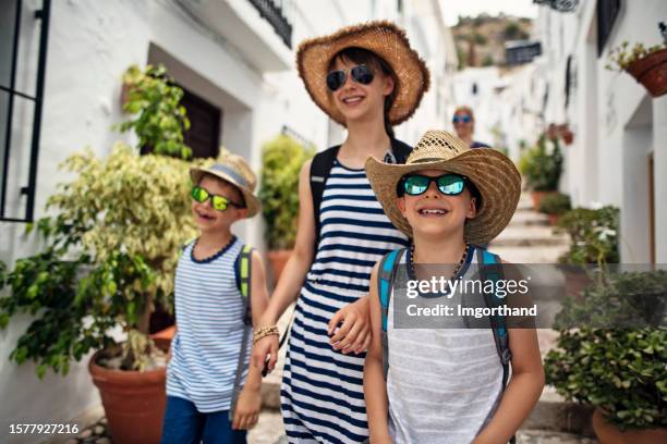 family sightseeing a town in andalusia, spain - frigiliana stock pictures, royalty-free photos & images