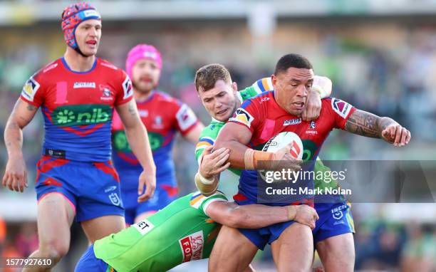 Nolan Stringer Tyson Frizell of the Knights is tackled during the round 22 NRL match ...