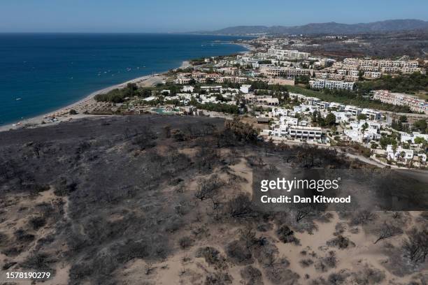 View along a blackened coastline on July 29, 2023 in Lardo, Rhodes, Greece. While A firefighting helicopter is still dealing with sporadic outbreaks...