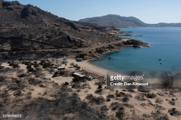Families on Glistra beach on July 29, 2023 in Lardos, Rhodes, Greece. The popular beach was ravaged by wildfire that also destroyed the up-market...