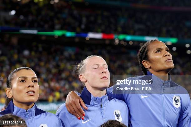 Clara Mateo, Eve Perisset and Wendie Renard of France line up for the national anthem prior to the FIFA Women's World Cup Australia & New Zealand...