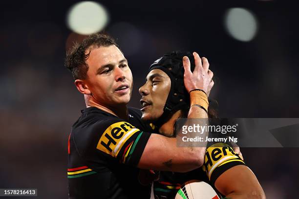 Dylan Edwards of the Panthers embrace with Jarome Luai of the Panthers during the round 22 NRL match between Penrith Panthers and Cronulla Sharks at...