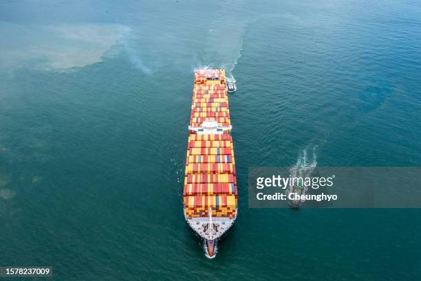 overhead view, large cargo ship in qingdao city, shandong province, china - tug boat stock-fotos und bilder