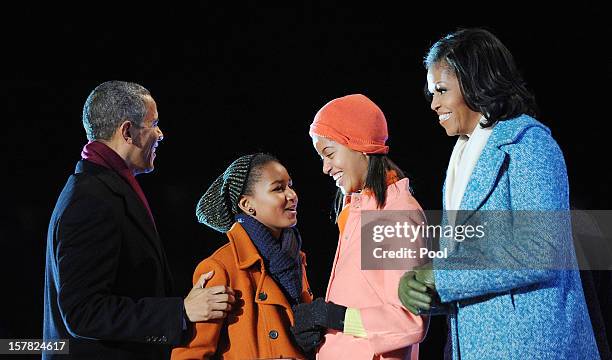 President Barack Obama with his wife first lady Michelle Obama and their daughters Malia and Sasha Obama light the 90th National Christmas Tree...