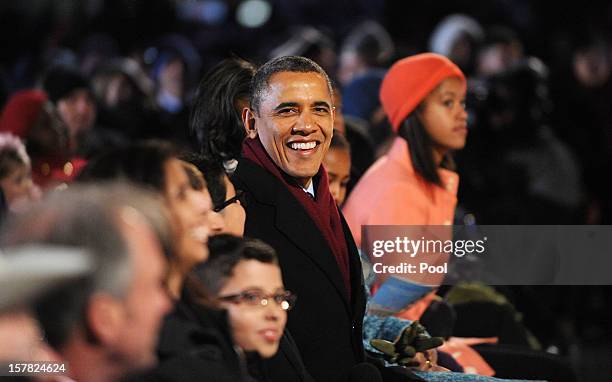 President Barack Obama with his wife Michelle Obama and their daughters Malia and Sasha Obama enjoying the concert during the 90th National Christmas...