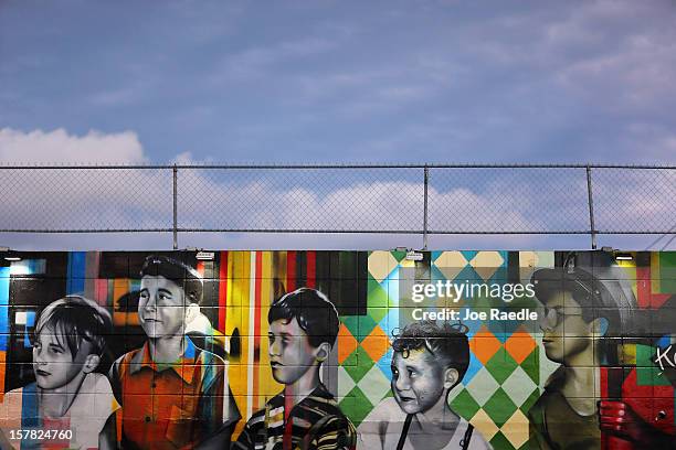 Paintings of children are seen on the wall of a building in the Wynwood Walls art project on December 6, 2012 in Miami, Florida. The art project...