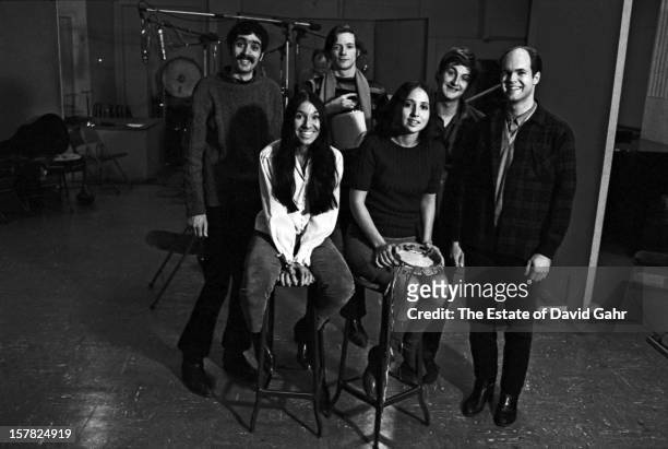 Singer songwriter Buffy Sainte-Marie and the Jim Kwenskin Jug Band pose for a portrait together on March 2, 1966 in the recording studios of Vanguard...