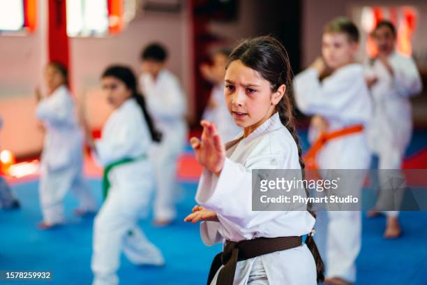 karate training, kids of different ages in kimono - taekwondo stock pictures, royalty-free photos & images