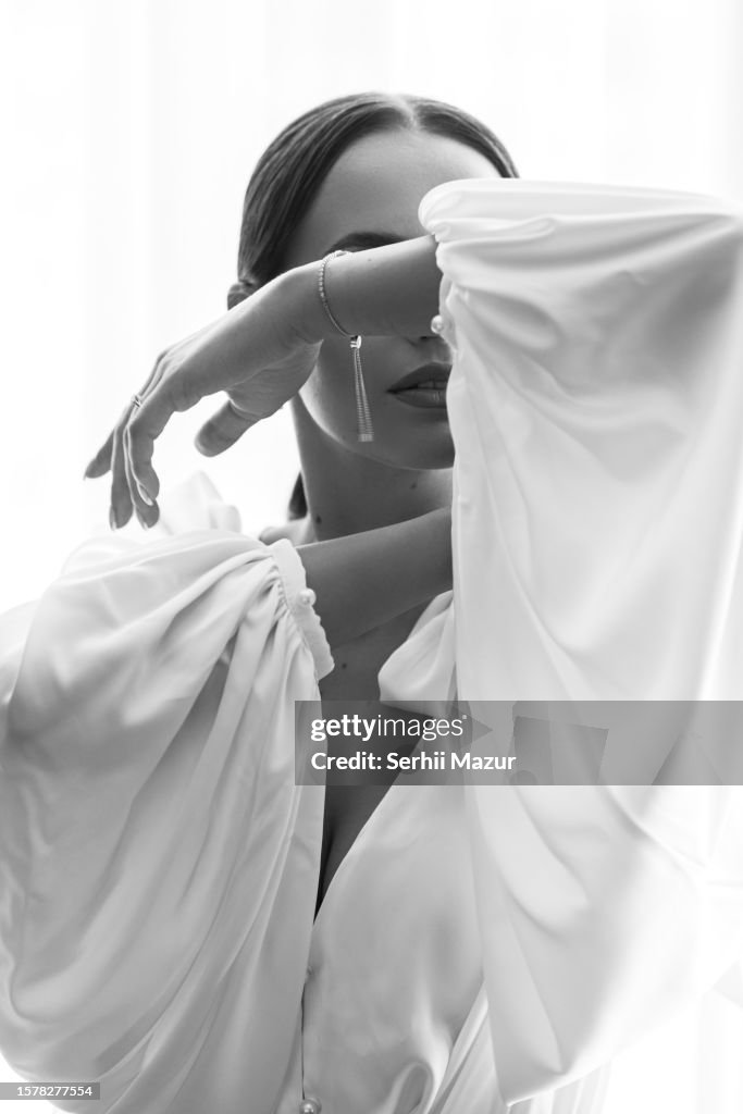 Gorgeous bride cover her face with hand - stock photo