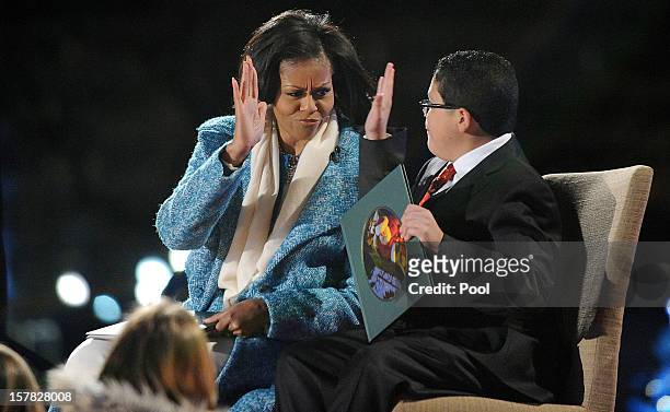 First lady Michelle Obama and Rico Rodriguez, actor on Modern Family read a story to kids during the 90th National Christmas Tree Lighting Ceremony...