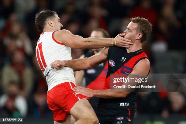 Tom Papley of the Swans collides with Darcy Parish of the Bombers as he celebrates kicking a goal during the round 20 AFL match between Essendon...