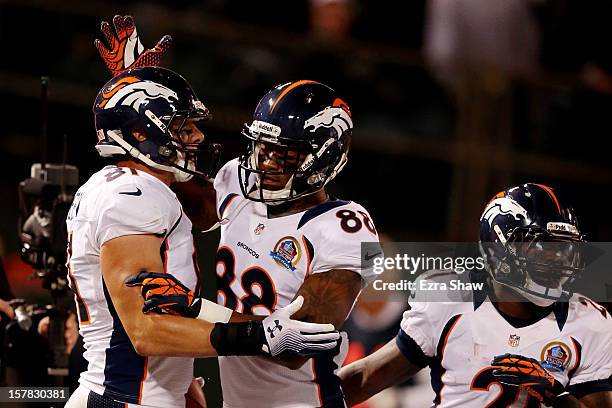 Joel Dreessen of the Denver Broncos is congratulated by his teammate Demaryius Thomas after scoring a touchdown in the first quarter against the...