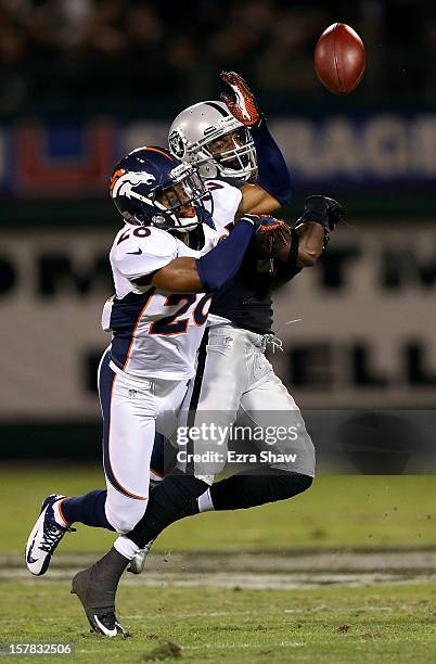 Rahim Moore of the Denver Broncos breaks up a pass intended for Denarius Moore of the Oakland Raiders at Oakland-Alameda County Coliseum on December...