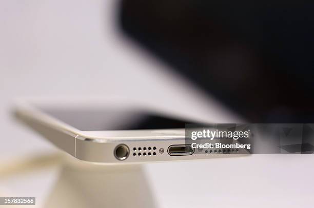 The dock connector is seen on an Apple Inc. IPhone 5 on display during a launch event organized by SK Telecom Co. In Seoul, South Korea, on Friday,...