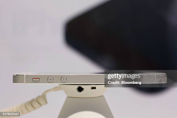 The ringer switch and volume buttons are seen on an Apple Inc. IPhone 5 on display during a launch event organized by SK Telecom Co. In Seoul, South...