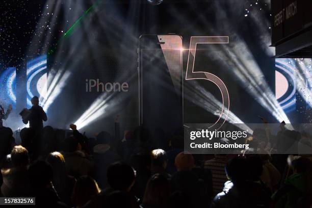 Customers await the sales launch of the Apple Inc. IPhone 5 during an event organized by SK Telecom Co. In Seoul, South Korea, on Thursday, Dec. 6,...