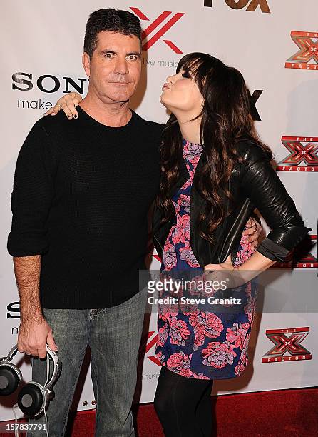Simon Cowell and Demi Lovato arrives at the "The X Factor" Viewing Party Sponsored By Sony X Headphones at Mixology101 & Planet Dailies on December...