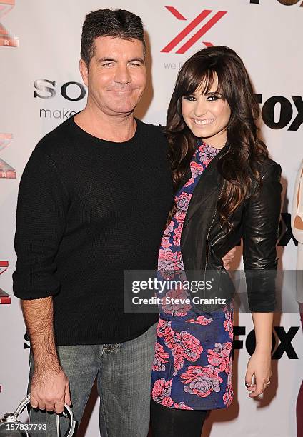 Simon Cowell and Demi Lovato arrives at the "The X Factor" Viewing Party Sponsored By Sony X Headphones at Mixology101 & Planet Dailies on December...