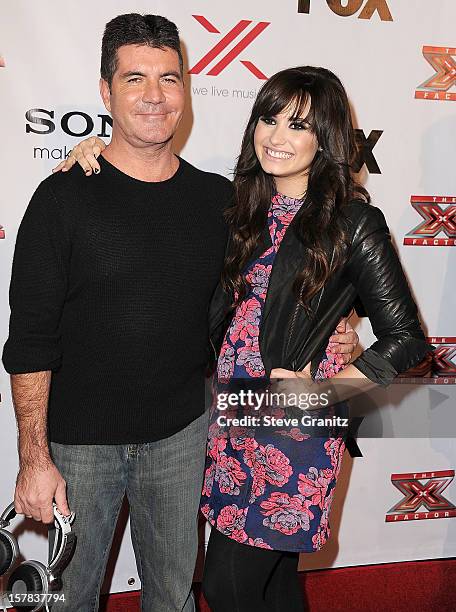 Simon Cowell and Demi Lovato arrives at the "The X Factor" Viewing Party Sponsored By Sony X Headphones at Mixology101 & Planet Dailies on December...