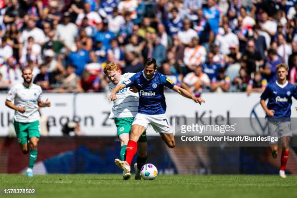 Steven Skrzybski of Holstein Kiel competes for the ball with runs off the ball ert Wagner of SpVgg Greuther Fürth during the Second Bundesliga match...