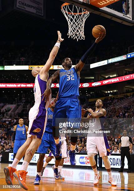 Mayo of the Dallas Mavericks lays up a shot past Marcin Gortat of the Phoenix Suns during the NBA game at US Airways Center on December 6, 2012 in...