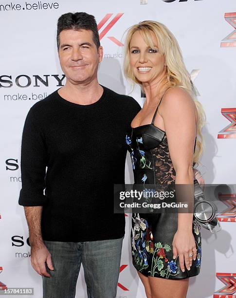 Personality Simon Cowell and singer Britney Spears arrive at FOX's "The X Factor" viewing party at Mixology101 & Planet Dailies on December 6, 2012...