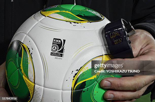Fbl-Asia-WClub-2012-technology by Peter Hutchison This photo taken on December 5, 2012 shows a FIFA official displaying new goal-line technology...