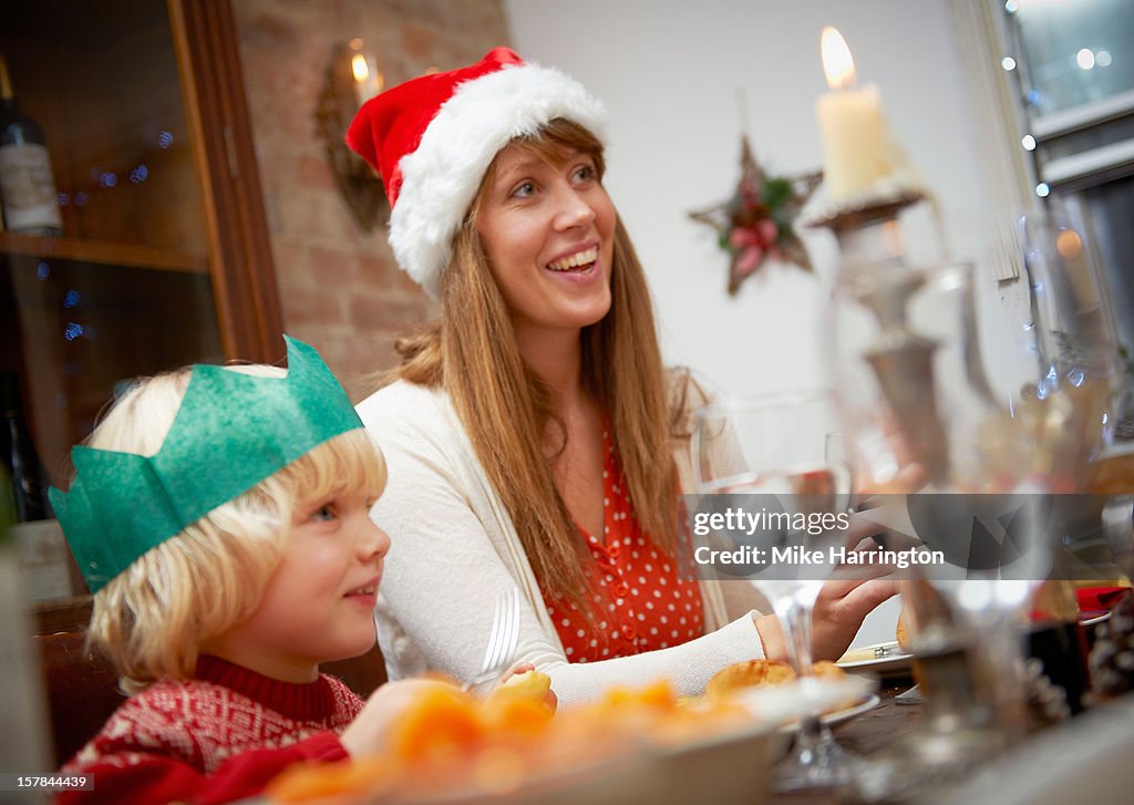 Mother and young son at dining table at Christmas