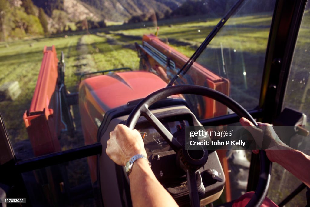 Woman's hands steering tractor