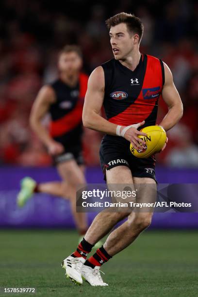 Zach Merrett of the Bombers runs with the ball during the round 20 AFL match between Essendon Bombers and Sydney Swans at Marvel Stadium, on July 29...