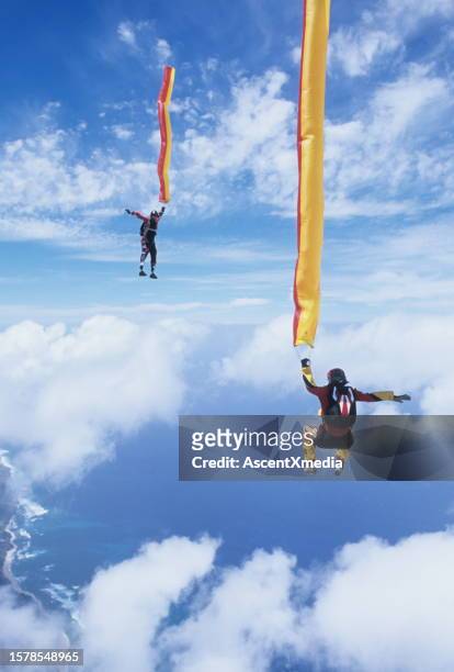 skydivers in free fall with colourful streamers - extreme sports point of view stock pictures, royalty-free photos & images