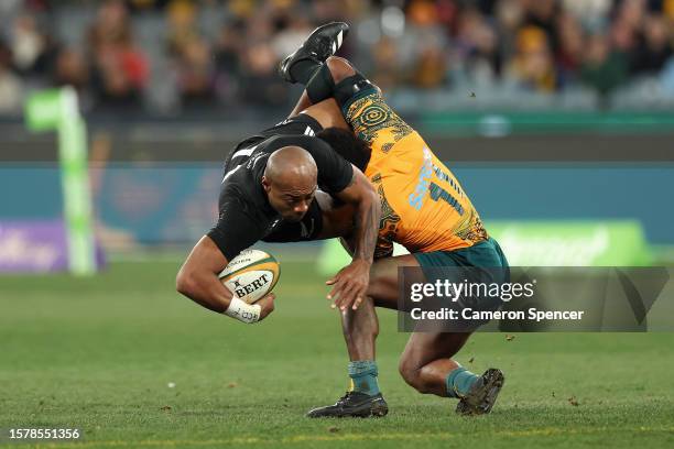 Mark Telea of the All Blacks is tackled by Marika Koroibete of the Wallabies during the The Rugby Championship & Bledisloe Cup match between the...