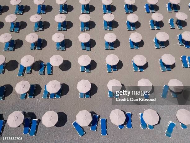 In this aerial view empty sun loungers line the beach at a resort on July 29, 2023 in Lardos, Rhodes, Greece. Since the wildfires that swept across...
