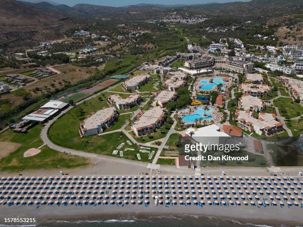 In this aerial view empty sun loungers line the beach at a resort on July 29, 2023 in Lardos, Rhodes, Greece. Since the wildfires that swept across...