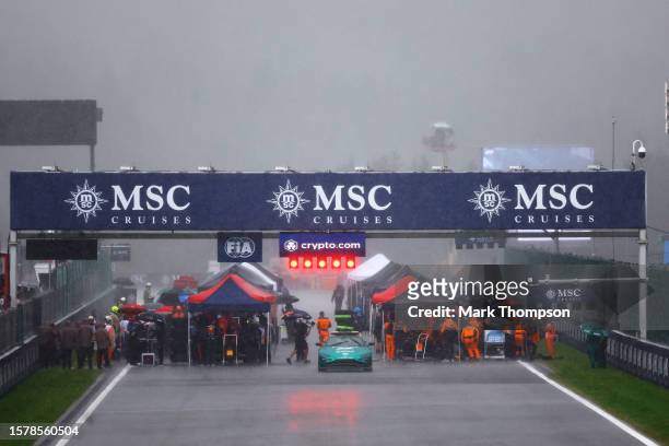 Teams shelter from the rain on the grid during the Sprint ahead of the F1 Grand Prix of Belgium at Circuit de Spa-Francorchamps on July 29, 2023 in...